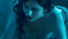 Woman in blue light looks down