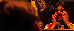 Woman peeling off bloody face mask