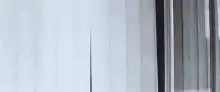 Man peeking through curtains