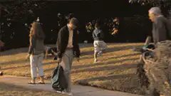 Man walking past red dog house