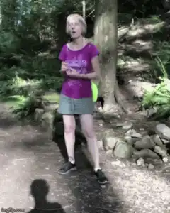 Woman dancing excitedly in the woods