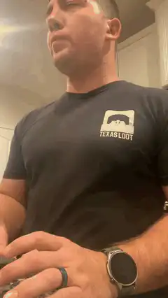 Man in Texas Loot shirt looking up