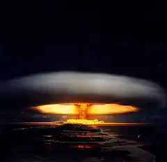 Nuclear bomb mushroom cloud over island