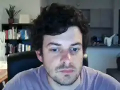 Man with curly hair looking at camera
