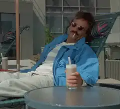 Jeff Bridges as The Dude relaxing with a drink