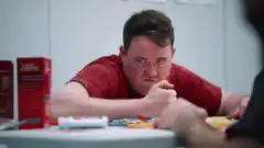 Man eating candy with intense stare
