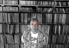 Man with glowing red eyes in library