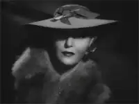 Woman in hat and fur smiles