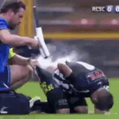 Soccer player gets cold spray treatment