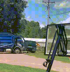 Garbage truck dumps trash on basketball hoop