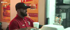 Two fast food workers clink cups