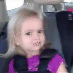 Blonde girl in car seat making a face