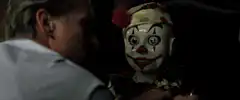 Michael Douglas stares at creepy clown doll