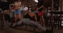 Man doing splits in a bar