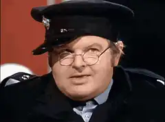Officer Dick Van Dyke smirking