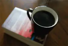 steaming coffee on a book