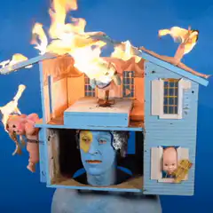 burning dollhouse with blue head