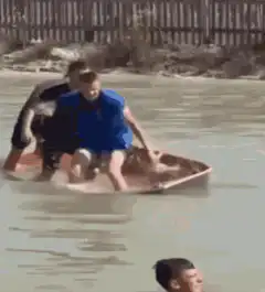Man salutes while sinking in water