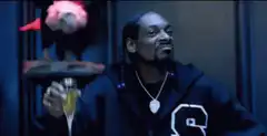 Snoop Dogg toasting and nodding