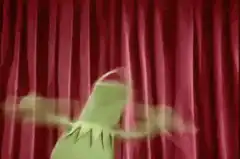 green puppet dancing on stage