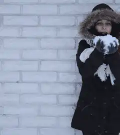 Girl throws snow in the air