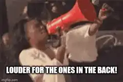 Woman shouting into megaphone louder for the ones in the back