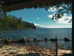 Tropical beach view from under a thatched roof