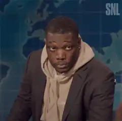 Michael Che puts on a hat