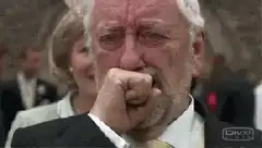 Old man crying in suit