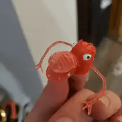 Red plastic bug finger puppet