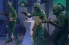 Three green aliens dancing