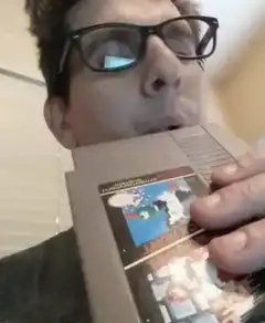 man eating nintendo cartridge