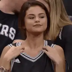 Selena Gomez adjusting jersey