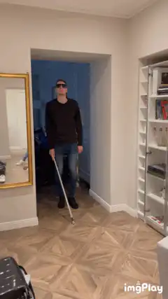 Man with white cane and sunglasses