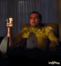 Leonardo DiCaprio pointing and drinking beer