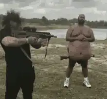 Two men with guns in a field