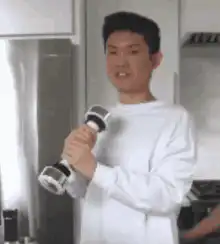 Man singing into a dumbbell