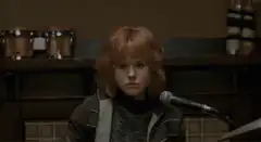 girl hits microphone with drumstick