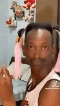 Man with pigtails and mustache blinking