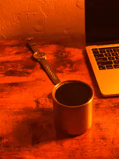 watch next to laptop and coffee
