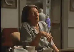 Old woman gestures with hand