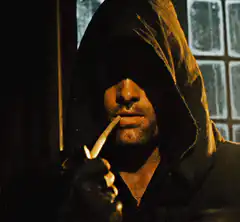 Man in hood with knife in mouth