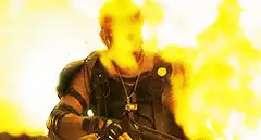 Dwayne Johnson smiles in front of fire