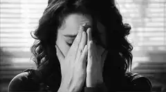Woman holding head in distress