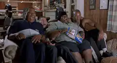 Four men laughing on a couch