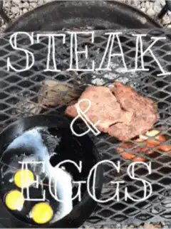 Steak and eggs cooking on a grill