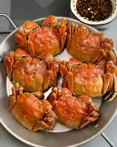 steamed crabs in pan with dipping sauce