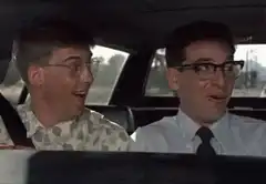 Two men laughing hysterically in a car