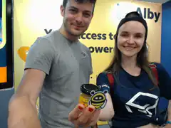 couple holding small jar at event