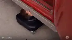 Fireman slides out from under truck